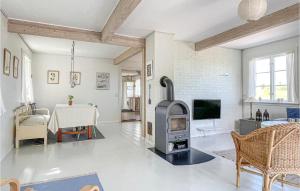 a living room with a wood stove and a table at Gorgeous Home In Gudhjem With Wifi in Gudhjem