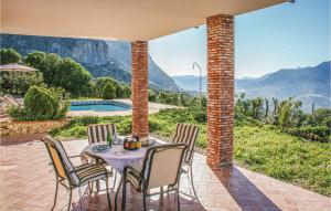a table and chairs on a patio with a view at Stunning Home In El Gastor With Wifi in El Gastor