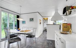 a kitchen and dining room with a table and chairs at Beautiful Home In Blvand With Wifi in Blåvand
