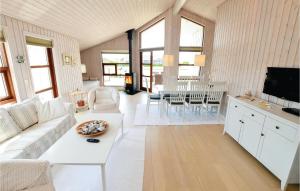 a living room with a white couch and a tv at 3 Bedroom Cozy Home In Sydals in Skovby