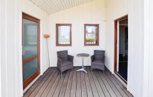 a patio with chairs and a table on a porch at Holiday Home Ellemose Sydals Ii in Skovby