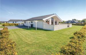 a house with a lawn in front of it at Holiday Home Ellemose Sydals Ii in Skovby