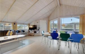 3 Bedroom Awesome Home In Fan في Sønderho: غرفة معيشة مع طاولة وكراسي