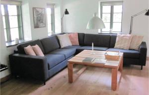 a living room with a blue couch and a coffee table at Holiday Home Brænderupvængevej in Gudme