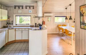 a kitchen and dining room with a table and chairs at Stunning Home In Nex With 5 Bedrooms, Sauna And Wifi in Bedegård