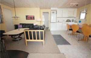 a living room and kitchen with a couch and a table at Awesome Home In Hejls With 3 Bedrooms, Sauna And Wifi in Hejls