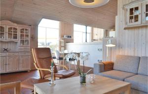 a living room with a couch and a table at 3 Bedroom Cozy Home In Hvide Sande in Havrvig