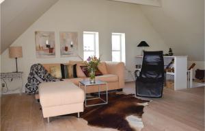 a living room with a couch and a table at One-Bedroom Holiday Home In Tranekar in Lohals