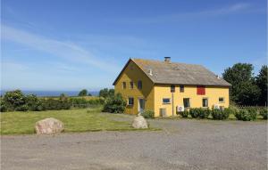 a yellow house sitting on top of a field at Awesome Apartment In Hasle With 2 Bedrooms And Wifi in Hasle
