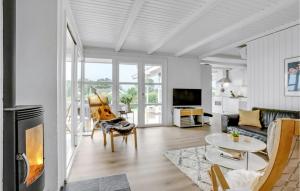 a living room with a couch and a table at Holiday Home Brombærvænget Hejls Ix in Hejls