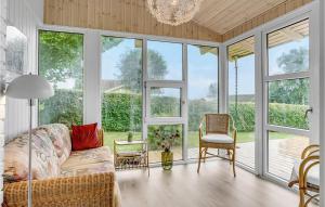 a living room with a couch and chairs and windows at Holiday Home Brombærvænget Hejls Ix in Hejls