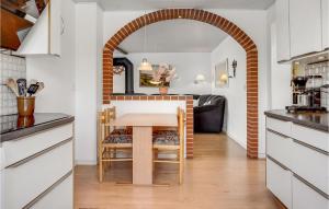 an archway in a kitchen with a table and chairs at Holiday Home Sønderballevej Rødekro Ix in Diernæs