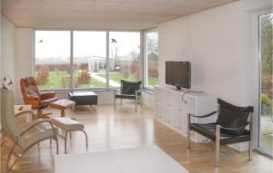 a living room with chairs and a tv and windows at Nice Home In Nrre Nebel With Wifi in Nørre Nebel