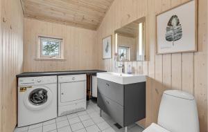 a bathroom with a washing machine and a sink at Cozy Home In Aakirkeby With Sauna in Vester Sømarken