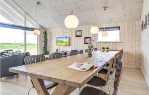 a dining room with a wooden table and chairs at Lovely Home In Bogense With Kitchen in Skåstrup