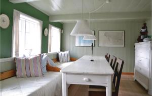a living room with a white table and a couch at Gorgeous Home In Fan With Kitchen in Sønderho