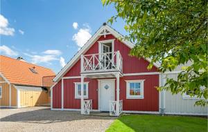 a red barn with a white at Holiday Home Strandgårdsvej Brenderup Fyn Denm in Bro