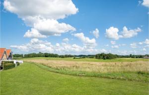 a view of a golf course with a grass field at Holiday Home Strandgårdsvej Brenderup Fyn Denm in Bro +23 photos
