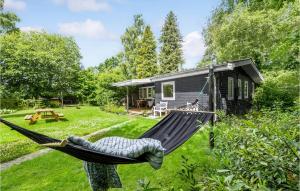 a hammock in front of a tiny house at Beautiful Home In Eg With Wifi in Egå