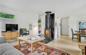 a living room with a fireplace and a table at Beautiful Home In Eg With Wifi in Egå