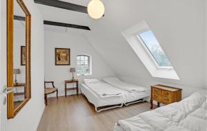 a bedroom with two beds and a mirror at Beautiful Home In Sllested With Kitchen in Søllested