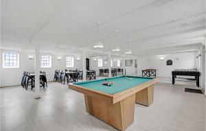 a pool table in a room with tables and chairs at Beautiful Home In Sllested With Kitchen in Søllested
