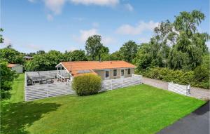 a house with an orange roof on a green yard at Pet Friendly Home In Svendborg With Wifi in Vemmenæs