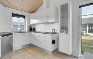 a kitchen with white cabinets and a large window at Amazing Home In Nrre Nebel With Wifi in Nørre Nebel