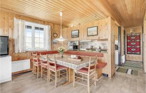 a kitchen and dining room with a table and chairs at Holiday Home Sønderho Strandvej Fanø in Sønderho
