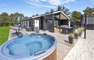 BjerregårdにあるHoliday Home Hvide Sande With A Fireplace 313の家の隣のデッキにあるホットタブ +25枚の写真