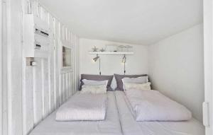 a white room with two beds in it at Cozy Home In Grenaa With House Sea View in Grenå