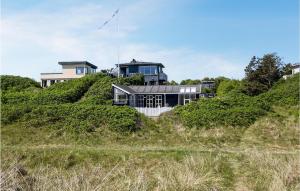 a house sitting on top of a hill at Cozy Home In Grenaa With House Sea View in Grenå