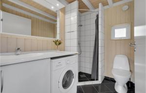 ein Badezimmer mit einer Waschmaschine und einem Waschbecken in der Unterkunft Cozy Home In Dronningmlle With Sauna in Dronningmølle