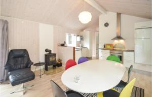 a living room with a white table and chairs at Holiday Home Gråpilevej in Bøtø By