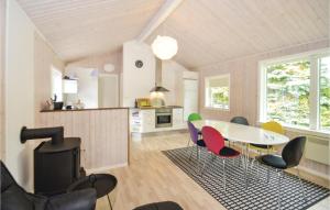 a kitchen and dining room with a table and chairs at Holiday Home Gråpilevej in Bøtø By