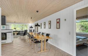 a kitchen and dining room with a table and chairs at Stunning Home In Fars With 5 Bedrooms, Sauna And Wifi in Hvalpsund