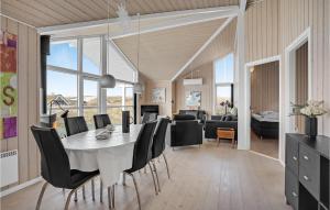 a dining room and living room with a table and chairs at Nice Home In Hvide Sande With House A Panoramic View in Havrvig