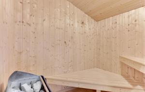 a wooden sauna with a chair in it at Holiday Home Pøt Strandby Ii Juelsminde I in Sønderby