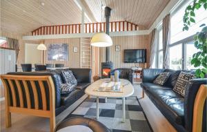 a living room with a couch and a table at Stunning Home In Ebeltoft With Kitchen in Ebeltoft