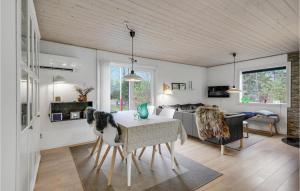 a living room with a table and a couch at Holiday Home Søgårdsvej Ansager in Ansager