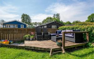 a backyard deck with furniture and a fence at Bedste Bo in Sønder Bjert