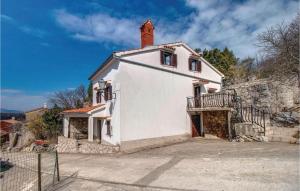 a white house with a tower on top of it at Beautiful Home In Dragozetici With 3 Bedrooms in Dragozetići