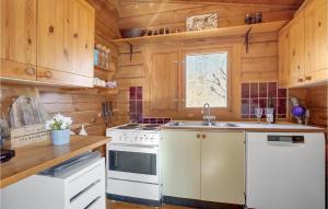 a kitchen with white appliances and wooden cabinets at Cozy Home In Mern With Wifi in Mern
