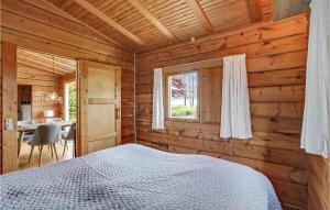 a bedroom with a bed in a wooden cabin at Cozy Home In Mern With Wifi in Mern