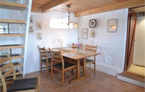 a dining room with a wooden table and chairs at Lovely Home In Give With House A Panoramic View in Give
