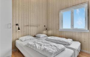 two twin beds in a room with a window at Nice Home In Faaborg With 4 Bedrooms, Sauna And Wifi in Faaborg