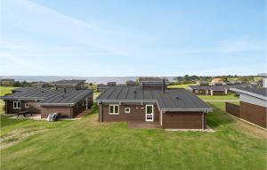 a group of houses in a field with grass at Nice Home In Faaborg With Kitchen in Fåborg