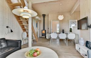 a dining room and living room with a table and chairs at Nice Home In Faaborg With Kitchen in Fåborg