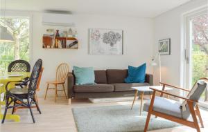 a living room with a couch and a table at Awesome Home In lsted With 3 Bedrooms And Wifi in Ølsted