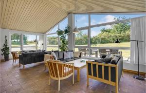 a living room with couches and a table at Amazing Home In Knebel With Private Swimming Pool, Can Be Inside Or Outside in Skødshoved Strand